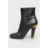 Heeled boots with metal inserts