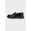 Black loafers with gold logo