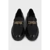 Black loafers with gold logo
