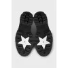 Black loafers with gold logo