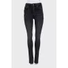 Black jeans decorated with slits