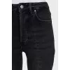 Black jeans decorated with slits