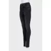 Black jeans decorated with slits