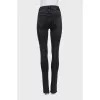 Black jeans decorated with slits