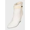 Suede ankle boots with a zipper and a wedge heel
