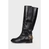 Leather boots decorated with chains