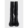 Leather boots decorated with chains