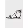 White leather sandals decorated with chains