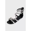White leather sandals decorated with chains
