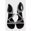 White leather sandals decorated with chains