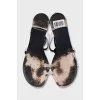 White leather sandals decorated with chains