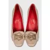 Beige leather shoes with a gold logo