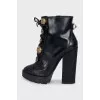 Black ankle boots with massive decor