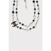 Black and white beaded necklace with logo