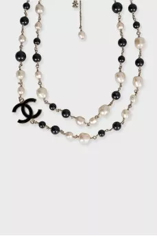 Black and white beaded necklace with logo