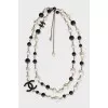 Black and white beaded necklace with logo