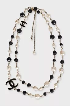 Black and white beaded necklace with logo