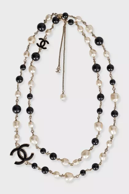 Black and white beaded necklace with logo