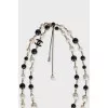 Black and white beaded necklace with logo