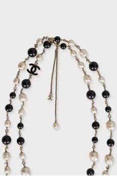 Black and white beaded necklace with logo