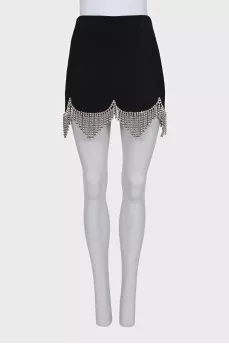A suit consisting of a cropped jacket and a crystal-embellished skirt