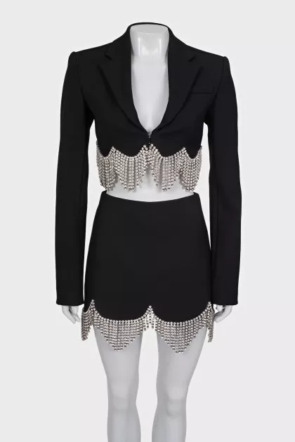 A suit consisting of a cropped jacket and a crystal-embellished skirt