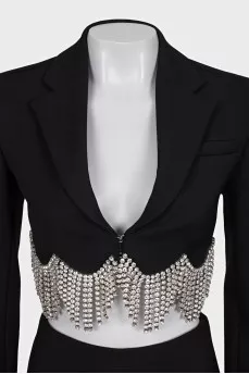 A suit consisting of a cropped jacket and a crystal-embellished skirt