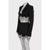 A suit consisting of a cropped jacket and a crystal-embellished skirt