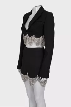 A suit consisting of a cropped jacket and a crystal-embellished skirt