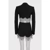 A suit consisting of a cropped jacket and a crystal-embellished skirt