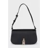Black shoulder bag with tag