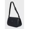Black shoulder bag with tag