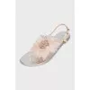 Silver sandals decorated with a flower