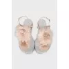 Silver sandals decorated with a flower