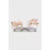 Silver sandals decorated with a flower