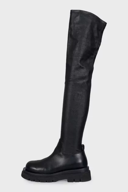 Black leather over-the-knee boots with a round toe