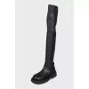 Black leather over-the-knee boots with a round toe