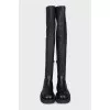 Black leather over-the-knee boots with a round toe