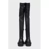 Black leather over-the-knee boots with a round toe
