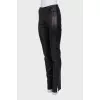 Black leather trousers with slits at the bottom