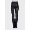 Black leather trousers with slits at the bottom