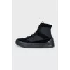 Black sneakers with suede inserts and a removable sole