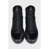 Black sneakers with suede inserts and a removable sole