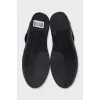 Black sneakers with suede inserts and a removable sole