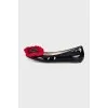 Patent leather ballet flats decorated with a flower