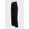 Wide-leg black jeans with gold hardware