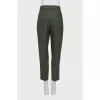 Green tapered trousers with creases