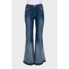 Flared jeans with buttons on the legs