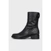 Black boots with branded embossing