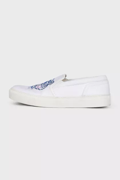 White slip-ons with branded embroidery